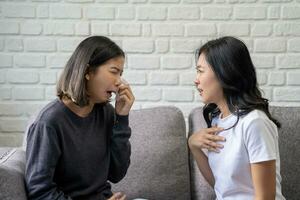 Asian woman with problems, Asian women embrace to calm their sad best friends from feeling down. photo
