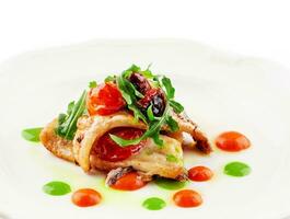 Fried white fish fillet with tomatoes and arugula photo