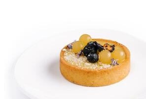 Lemon tartlet with blueberries and grapes photo