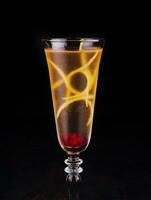 Elegant glass of yellow champagne with raspberry photo