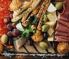 Cheese, meat, grapes and olives antipasto photo