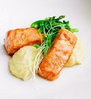 salmon steaks with mashed potatoes on white plate photo