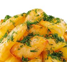 Fried potato slices with dill on plate photo