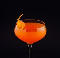 Fresh orange alcoholic drink with orange peel photo