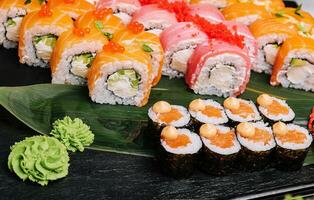 different types of sushi rolls on big plate photo