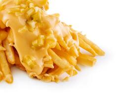 Pouring cheese sauce on french fries on white background photo