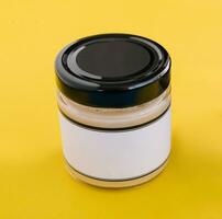 salad dressings in glass jar on yellow background photo
