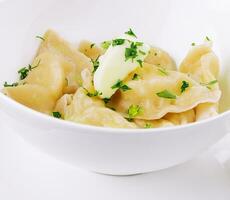 Delicious cooked dumplings and sour cream photo