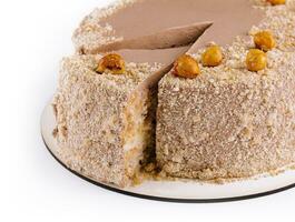Kiev cake with hazelnut on white plate top view photo
