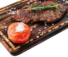 Grilled beef steak on wooden board photo