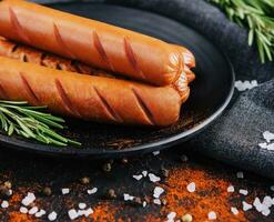 tasty sausages with rosemary close up photo