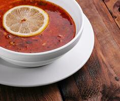 Traditional Ukrainian meat soup Solyanka in bowl photo