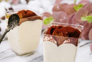 Traditional italian dessert tiramisu in a glass photo