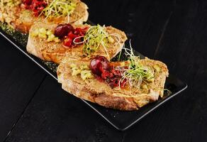 Healthy toasts with salmon pate and fresh green sprouts photo