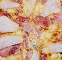 Delicious meat pizza with salami, ham and cheese photo