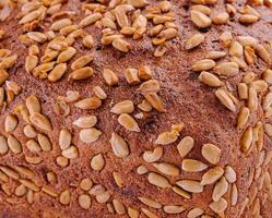 rye bread with sunflower seeds on a white photo