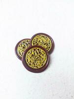 Close up shot of colorful wax coin for wedding invitation decoration or vintage look for a letter. Top view. photo