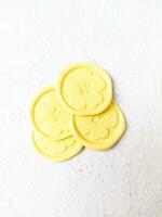 Close up shot of colorful wax coin for wedding invitation decoration or vintage look for a letter. Top view. photo