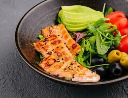 salad with grilled salmon, avocado, tomatoes with arugula photo