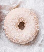 sweet donut with coconut flakes, top view photo