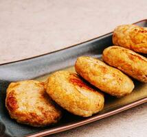 Delicious homemade cutlets in ceramic plate photo