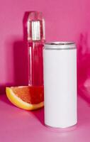 soda in a tin and perfume on a pink background photo