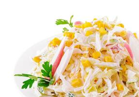 Salad with corn, crab sticks, cucumbers, eggs and mayonnaise photo