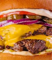 Large cheeseburger with two beef patties grilled photo