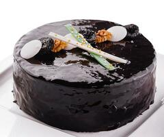 Tasty chocolate cake with prunes and nuts photo