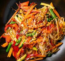 Asian vegetarian udon noodles with vegetables in a bowl photo