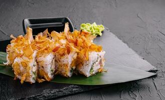 Sushi bonito roll on black stone photo