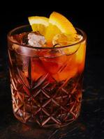 Classic Negroni Cocktail with orange slices in glass photo