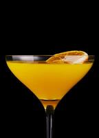 Orange martini or Margarita cocktail on black photo