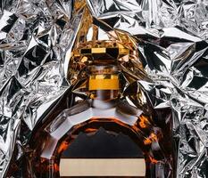 bottle of cognac in foil top view photo