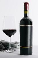 Red wine and wine bottle on stone photo