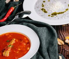 different vegetable cream soups on wooden photo