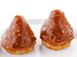 triangular cake with toffee jam on plate photo