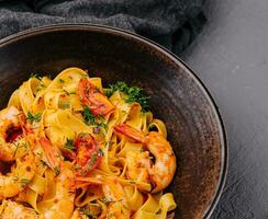 Fettuccine pasta with shrimp and tomatoes photo