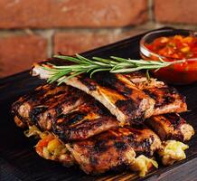 Bbq pork ribs grilled with tomatoes herbs photo