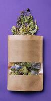 Paper bag with scattered dried tea photo