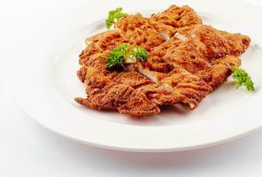 Chicken schnitzel sliced on white plate photo