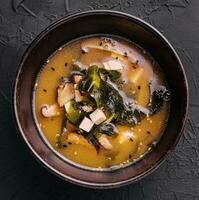 Soup with algae and mushrooms top view photo