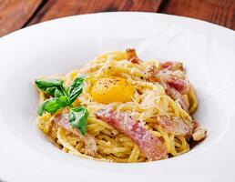 Pasta carbonara with bacon, egg and cheese photo