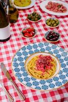 Pasta spaghetti with different types of olives and wine photo