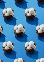 Coconuts with candies on blue table photo