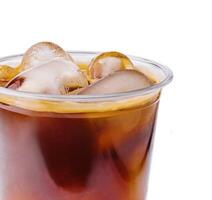 Cola with ice in plastic glass on white background photo