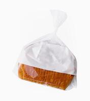 Loaf of wheat bread in plastic bag isolated photo