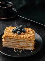 cake napoleon with blue blueberries and tea cup photo