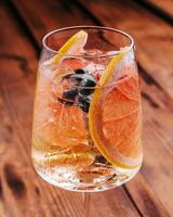 Alcoholic cocktail with grapefruit, soda, ice and gin photo