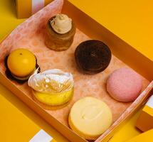 different mousses cakes in gift boxes photo